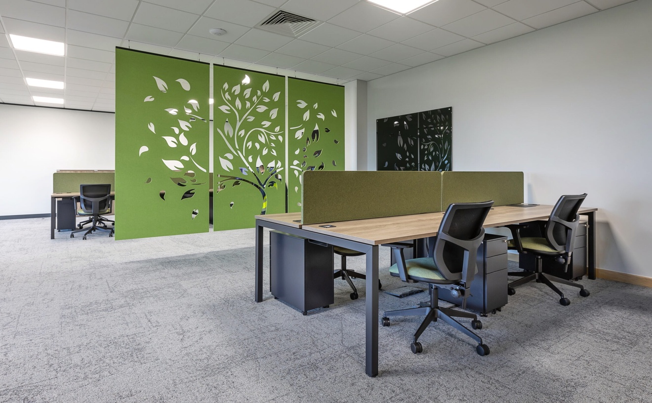 office desk set up with green tree decorative artwork