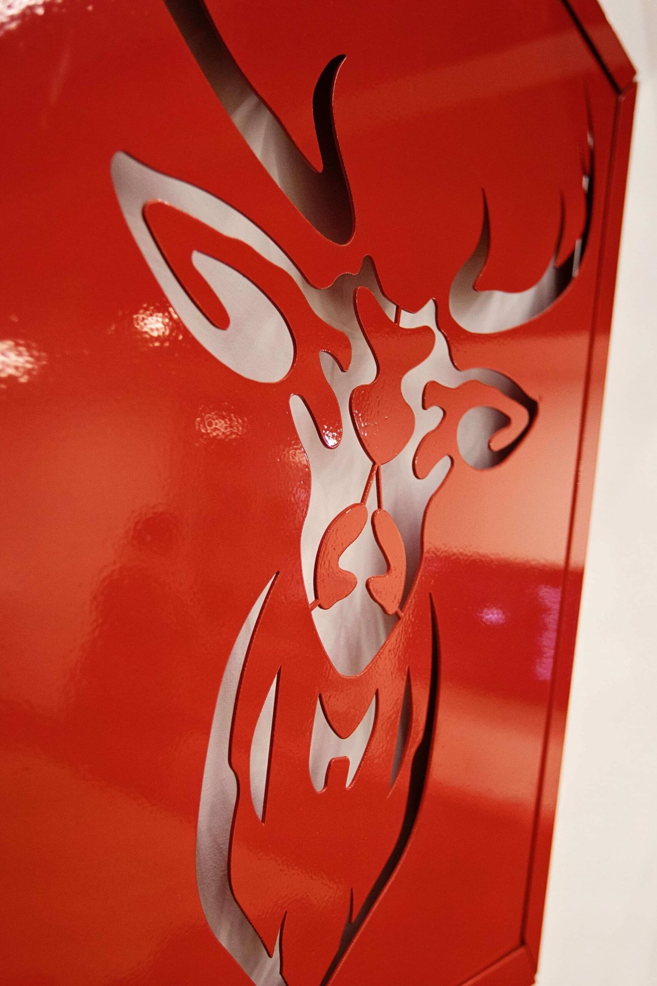 A metal sheet with the outline of a deer cut out of it.
