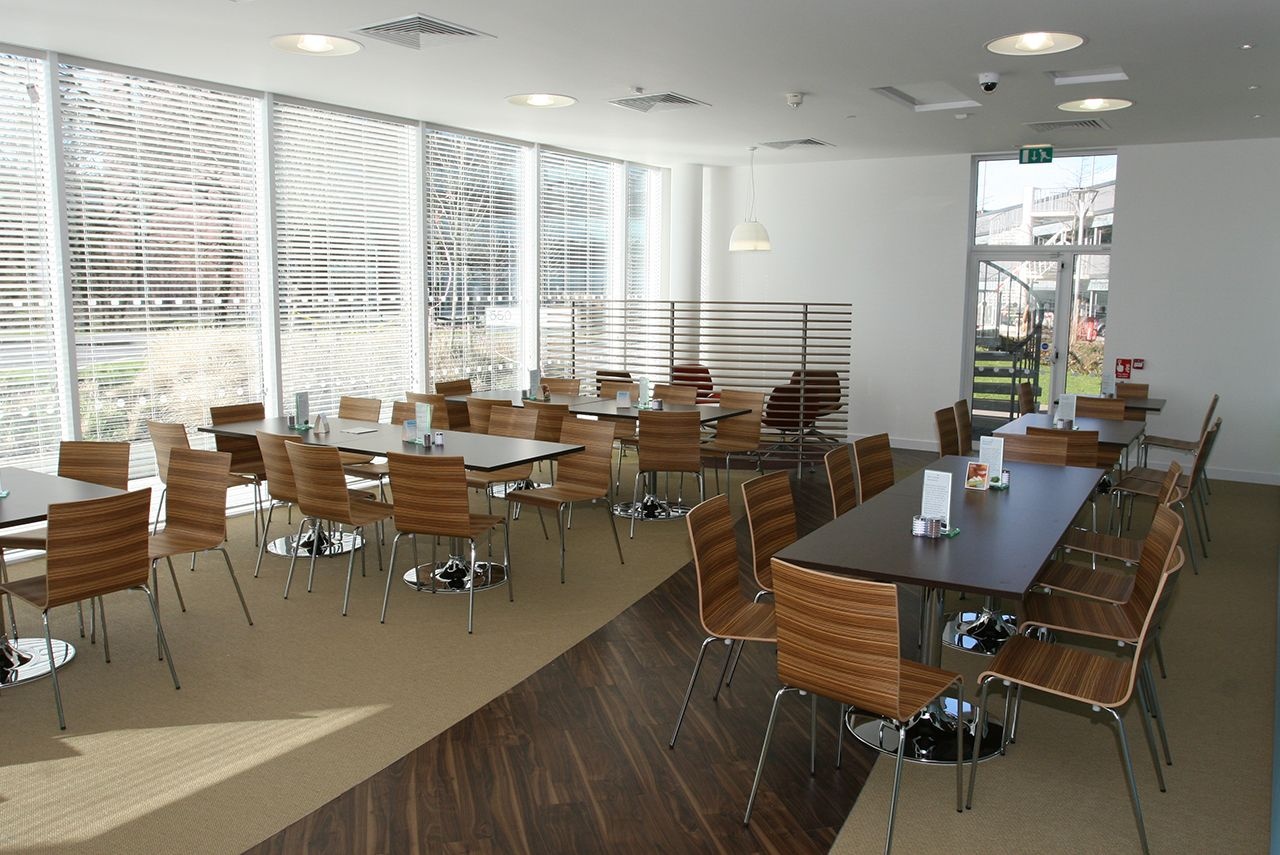 An empty cafe, filled with tables and chairs.