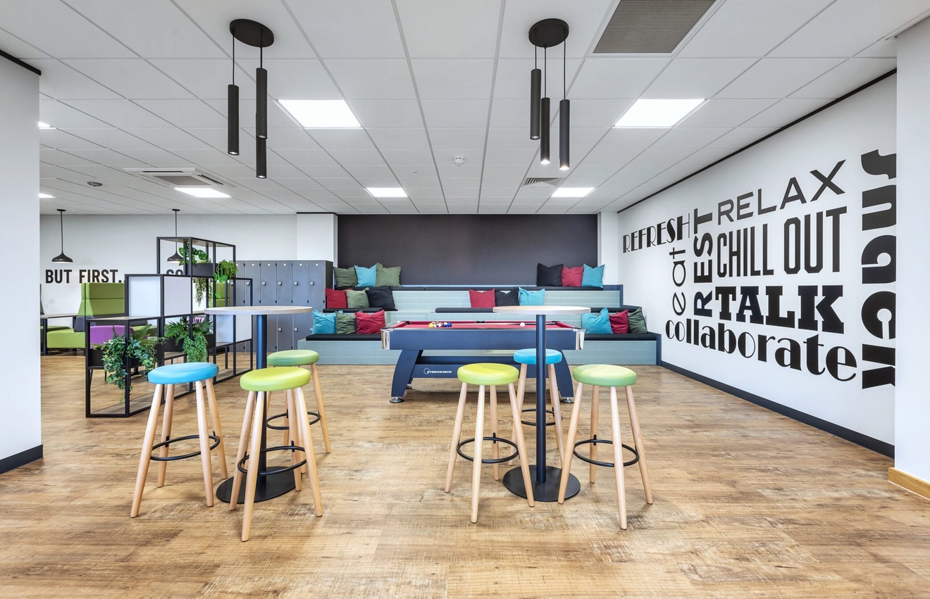 office breakout room with pool table and step seating areas