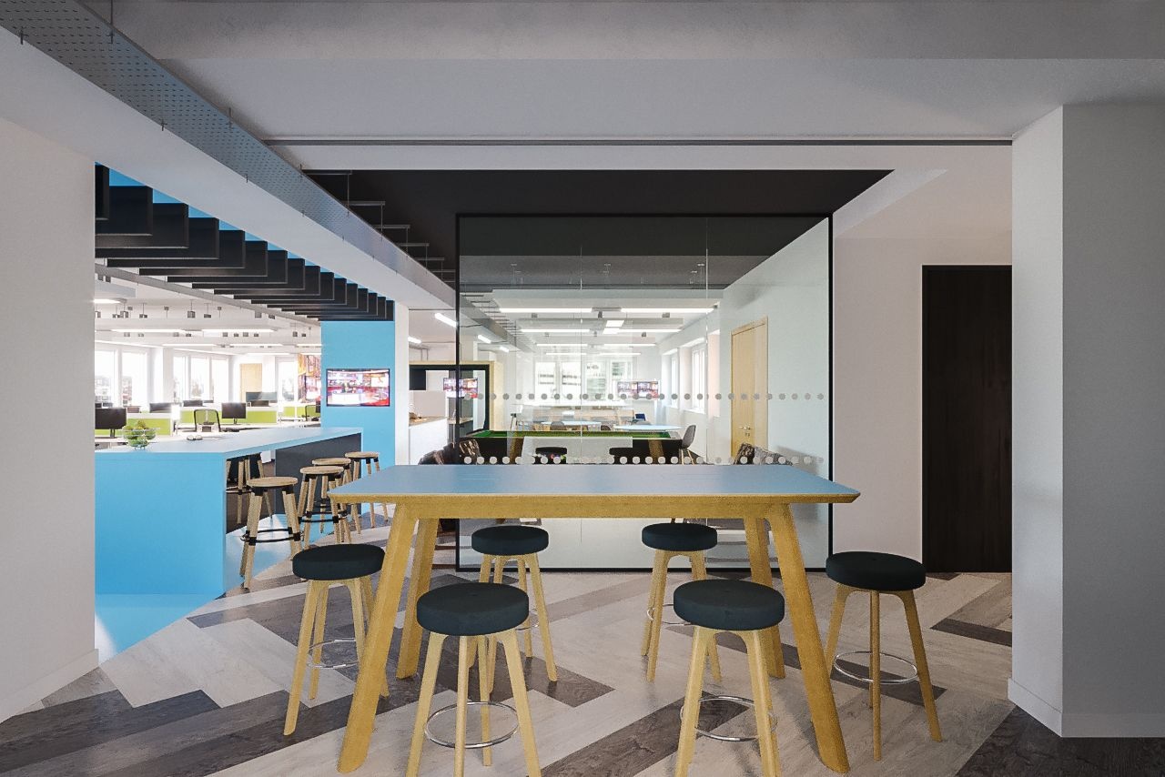 A high table surrounded by stools with an empty office in the background.